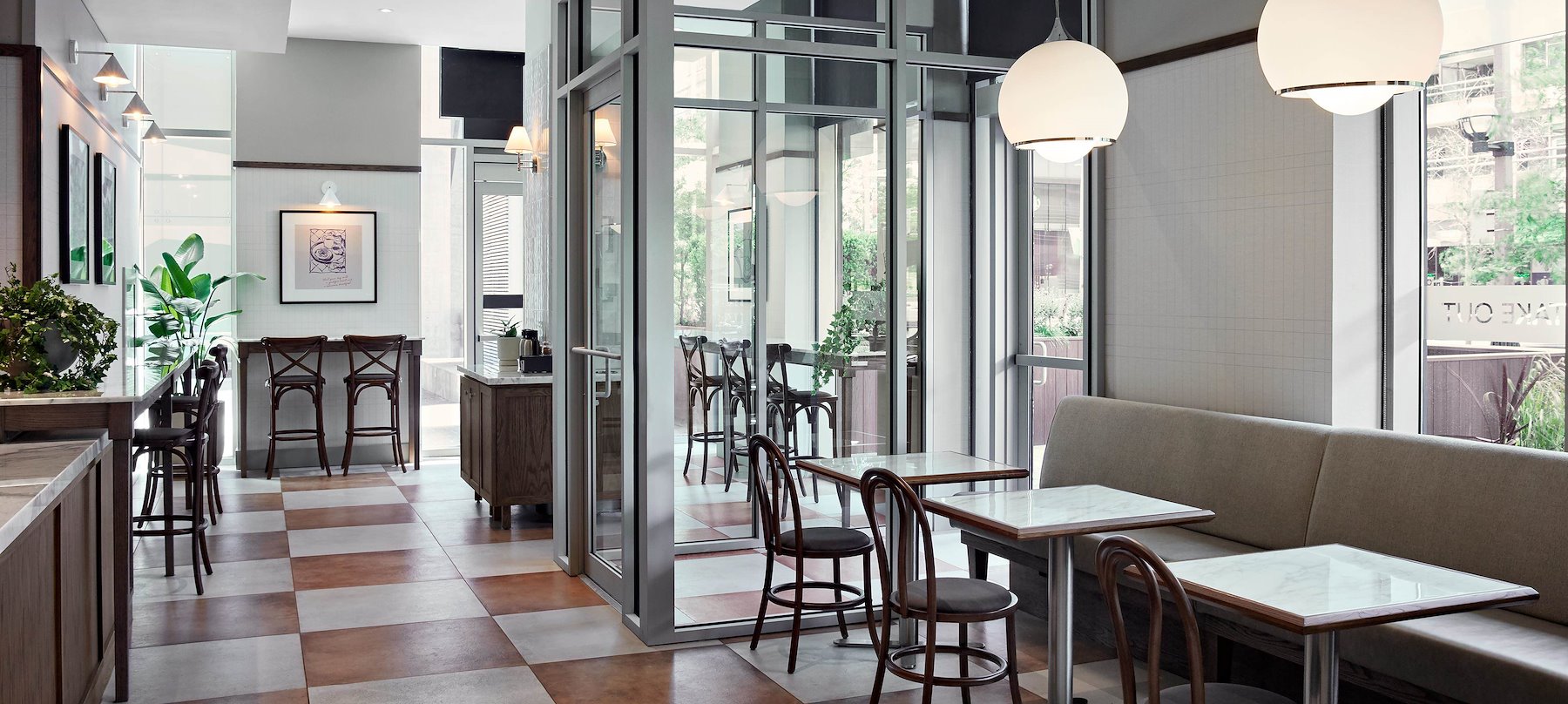 Modern cafe with checkered floor, wooden chairs, and large windows located at Southcore in Downtown Toronto.