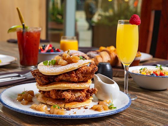 Fried Chicken and pancakes, mimosa in a champagne glass with a strawberry